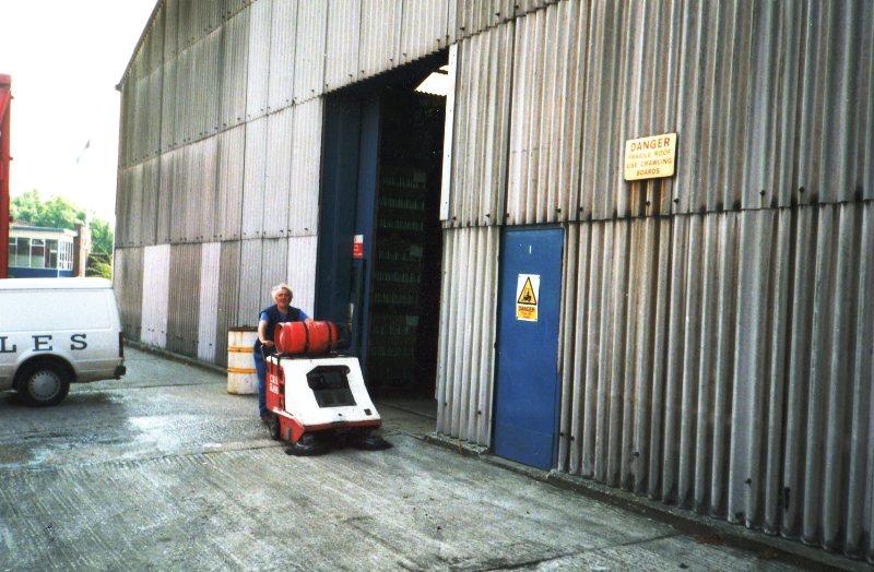 Joe Walker sweeping warehouse yard