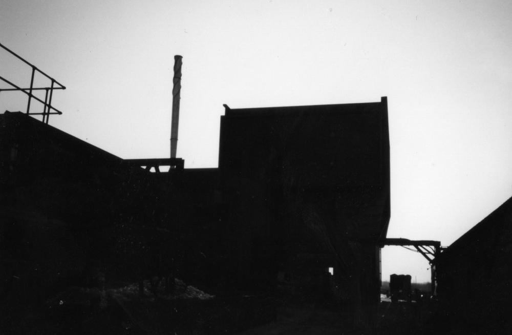 Silhouette of rear of Glass works