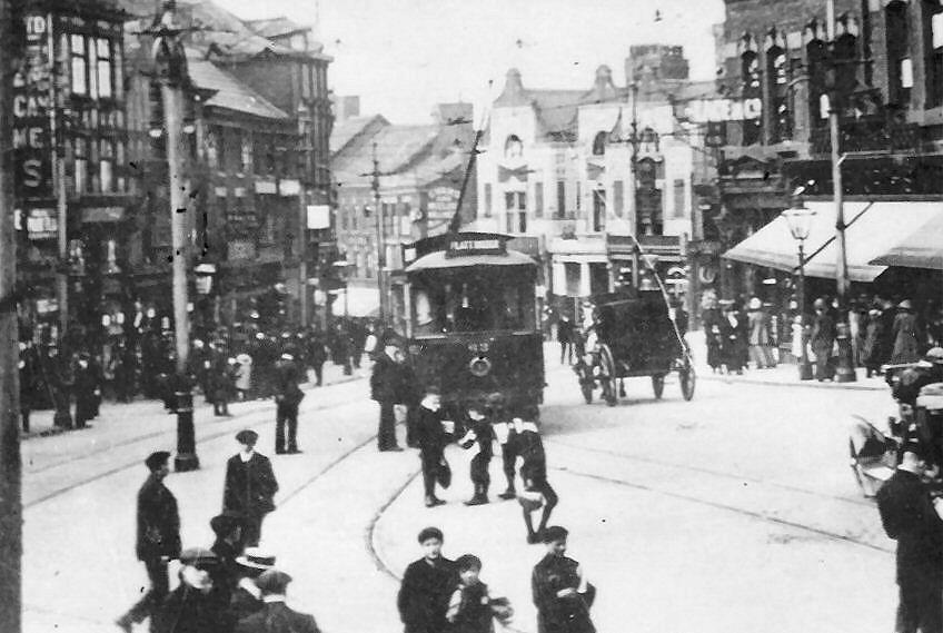 Wigan Corporation Tram in a busy Market Place.