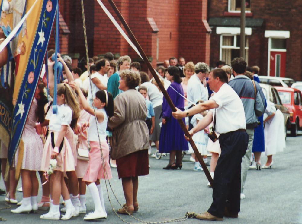 Denis Linley prepares to lift banner