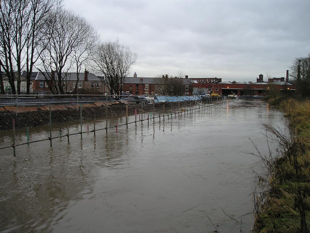 View from the opposite river bank towards Melverley Street & bus depot.