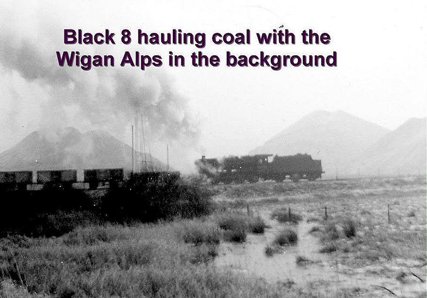Black 8 hauling coal with the Wigan Alps in the background. Black 8 hauling coal with the Wigan Alps in the background.
