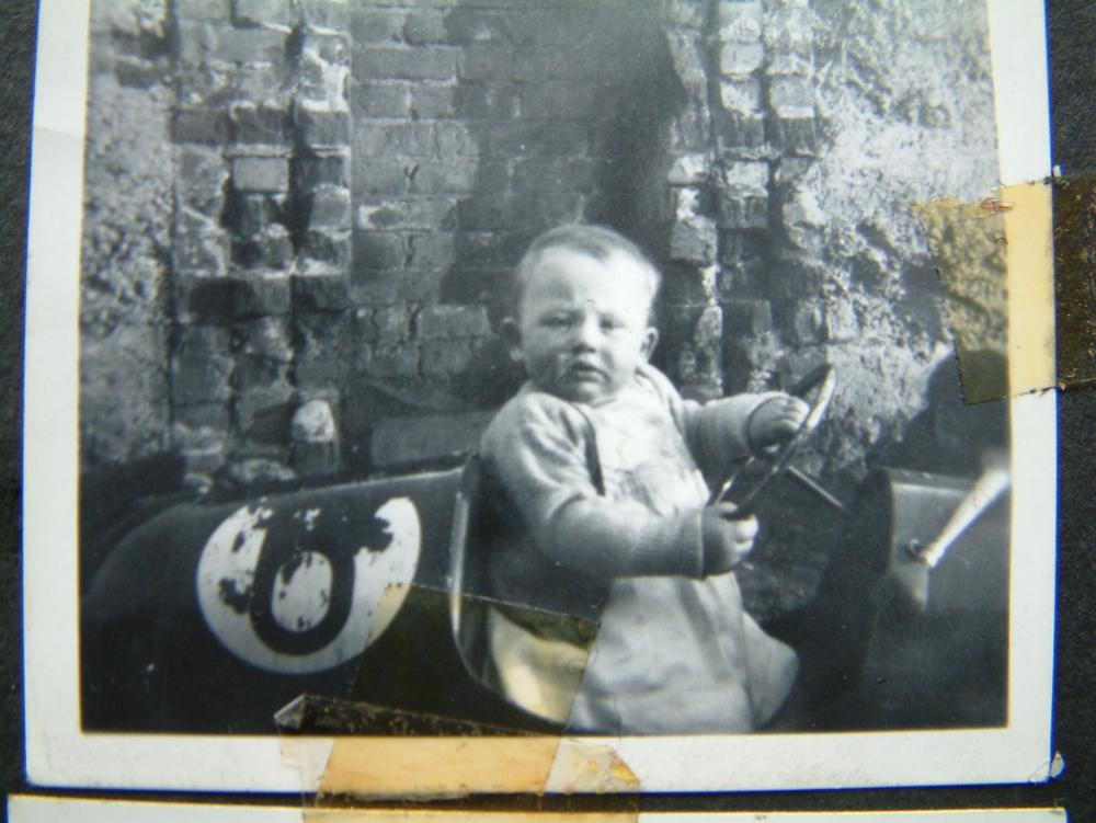 My sister Margaret sitting in my pedal car