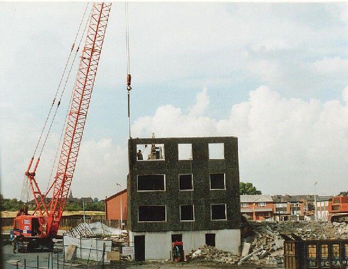 Removing some the last black panels from the building.