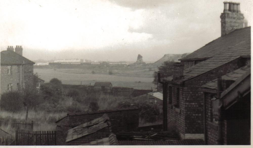 view of mains pit with steam train on the horizon