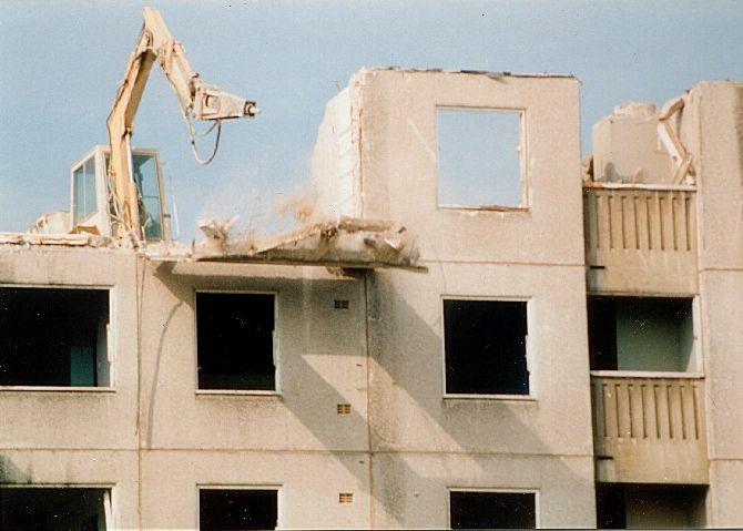 Telephoto lens shot of Panel being knocked off building.