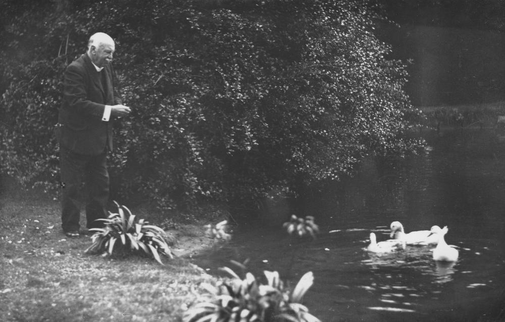 Rector Hutton feeding ducks in the pond at his Rectory