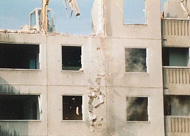 Telephoto lens shot of Debris falling from building.
