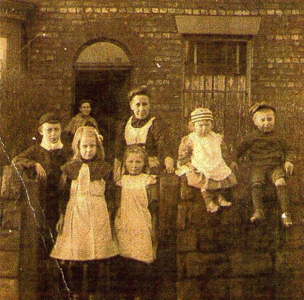 Elizabeth Ellen Bradshaw with her children outside their house in Newtown.