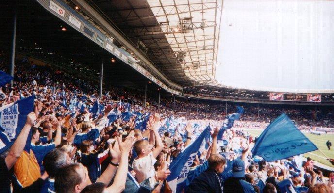 Latics supporters greet the team as they emerge from the tunnel.