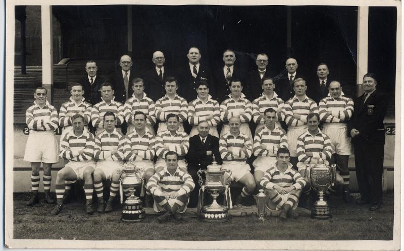 Team with Officials and trophies.