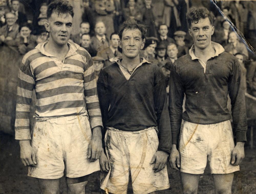 Unknown Player plus two other opposition players Unknown Player plus two other opposition players