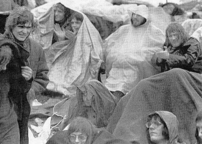 Fans brave the lashing rain.