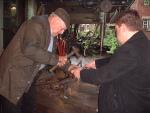 Fred and Neil Baxter rivet a boiler door for the traction engine (72K)