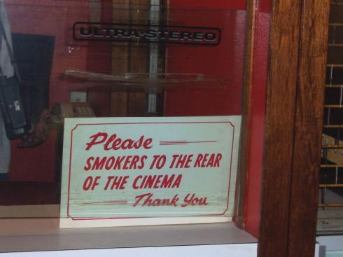 Sign reads 'Please - Smokers to the rear of the cinema' Sign reads 'Please - Smokers to the rear of the cinema'