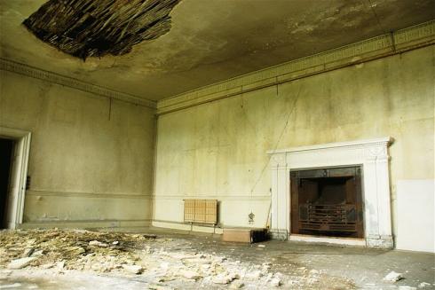 Feature fireplace in room with damaged ceiling