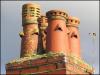 Chimney pots in Standish, with weed.